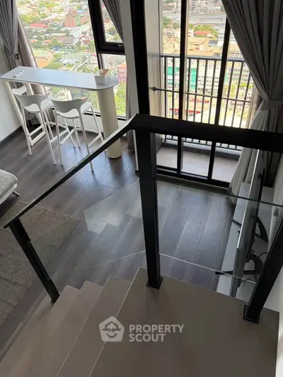 Modern duplex apartment with stunning city view from balcony and stylish interior design.