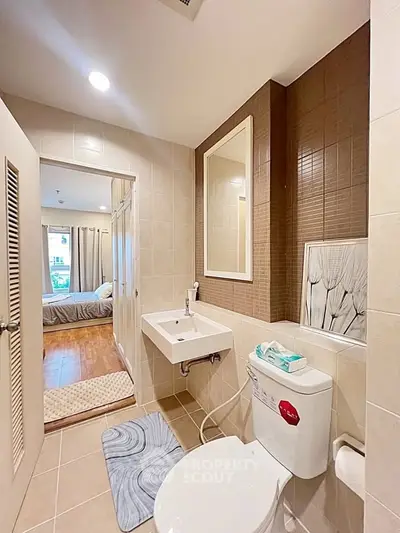 Modern bathroom with sleek design and adjacent bedroom view