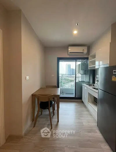 Modern kitchen with open layout and city view from balcony