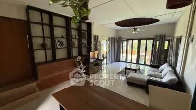 Spacious living room with modern decor and large windows offering natural light.