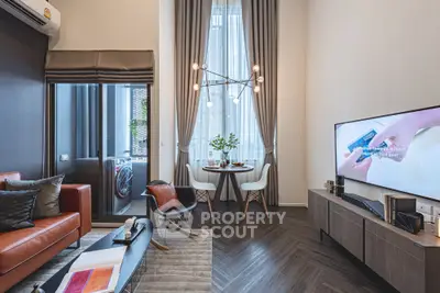 Modern living room with stylish decor and high ceiling, featuring a cozy seating area and dining space.