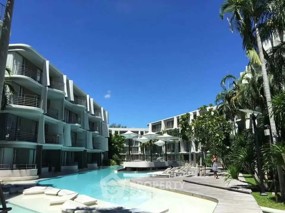 Luxurious resort-style apartment complex with stunning pool and lush greenery.