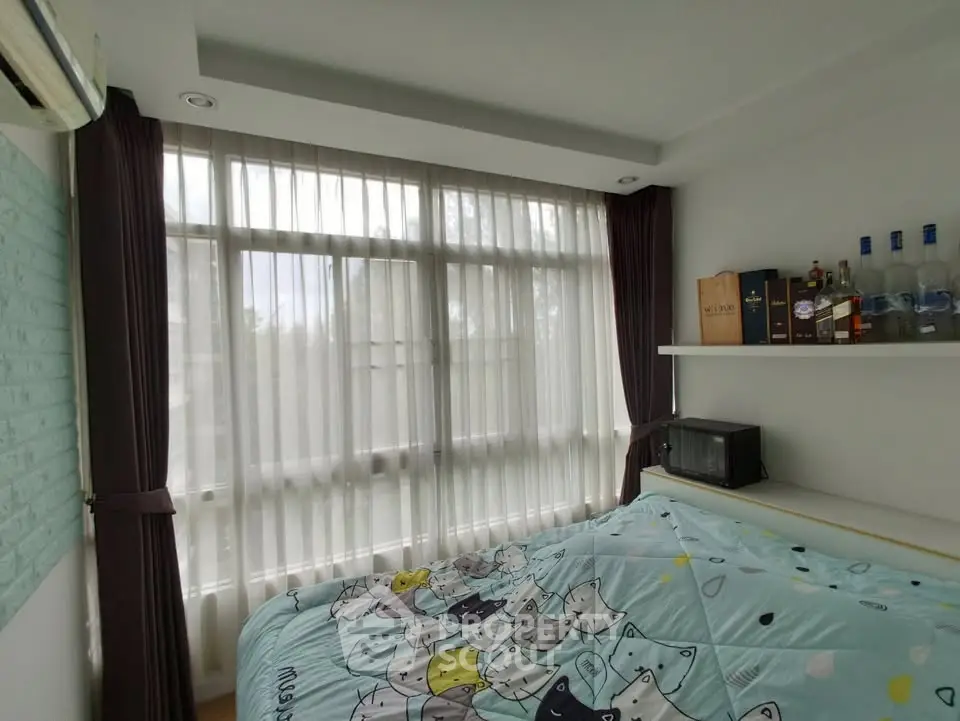 Cozy bedroom with large window and stylish decor