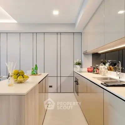 Modern kitchen with sleek cabinetry and island, featuring open layout and contemporary design.