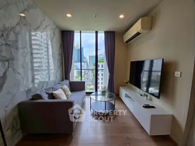 Modern living room with city view, stylish decor, and natural light