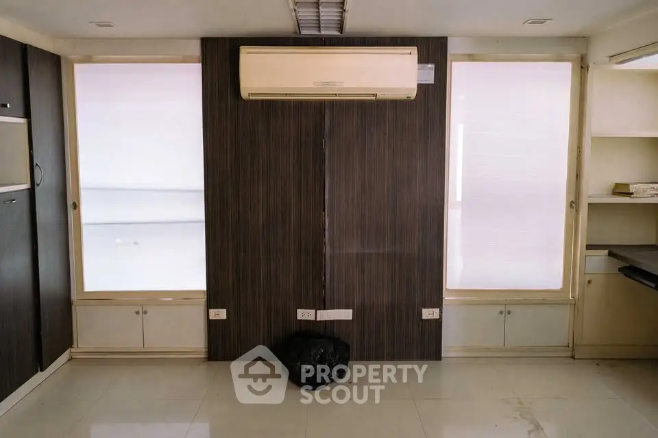 Modern interior with air conditioning and built-in storage, ideal for home office or study space.