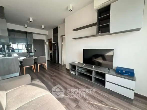 Modern living room with sleek furniture and open kitchen layout, perfect for contemporary living.