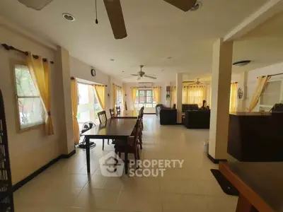 Spacious open-plan living and dining area with natural light and elegant decor.