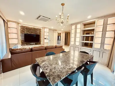 Luxurious living room with marble dining table and elegant chandelier