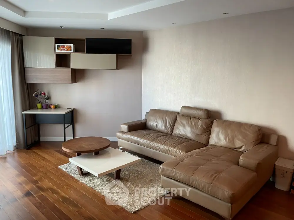 Modern living room with stylish furniture and wooden flooring