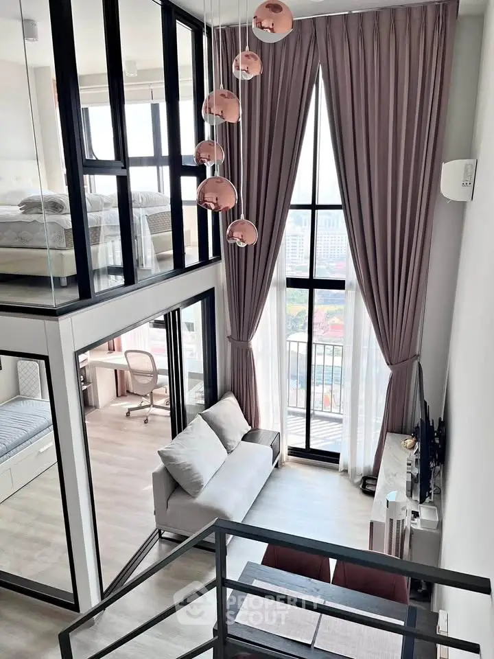 Modern loft apartment with high ceilings, large windows, and stylish decor, featuring a mezzanine bedroom and cozy living area.