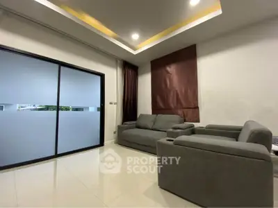 Modern living room with sleek furniture and large sliding glass doors