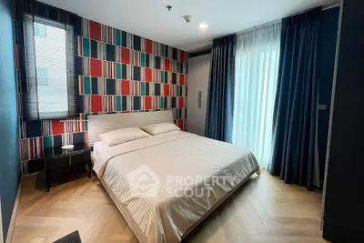 Stylish bedroom with modern decor and natural light in a contemporary apartment.