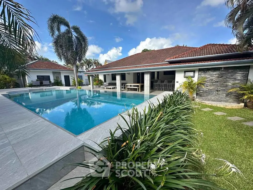 Luxurious villa with stunning pool and lush garden, perfect for relaxation and entertaining.