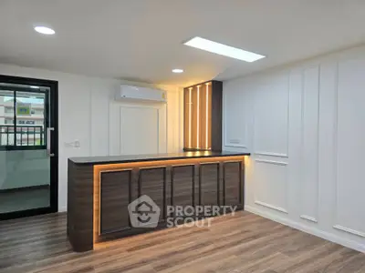 Modern interior with stylish wooden bar counter and elegant lighting in a contemporary living space.