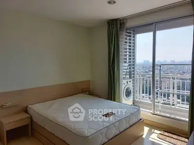 Bright bedroom with city view and balcony access in modern apartment