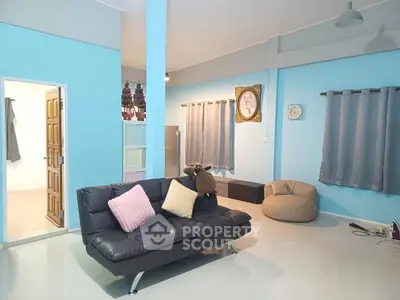 Spacious living room with modern decor and comfortable seating in a stylish home.
