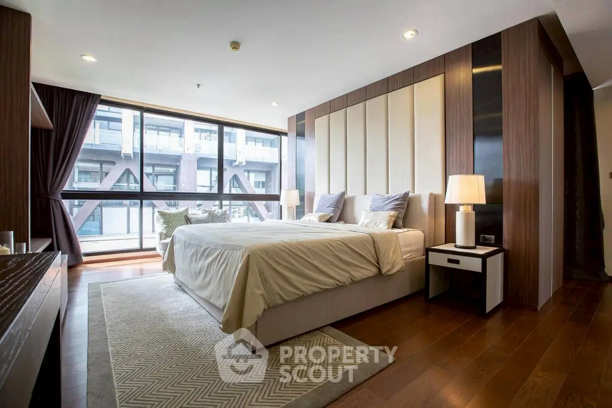 Luxurious bedroom with modern decor and large windows offering city view