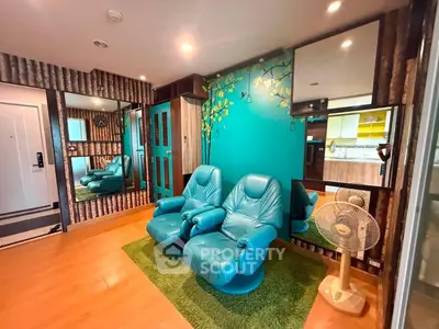 Stylish living room with blue recliners and vibrant wall art in modern apartment