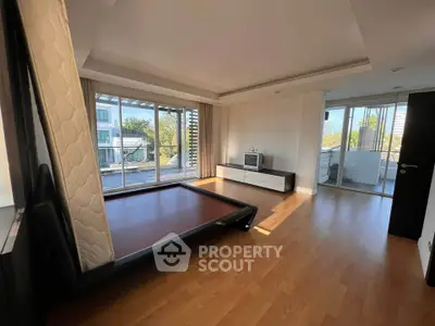 Spacious living room with large windows and balcony access in modern apartment