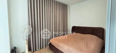 Cozy bedroom with elegant curtains and a comfortable bed, perfect for relaxation.
