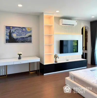 Modern bedroom with sleek TV unit and elegant decor