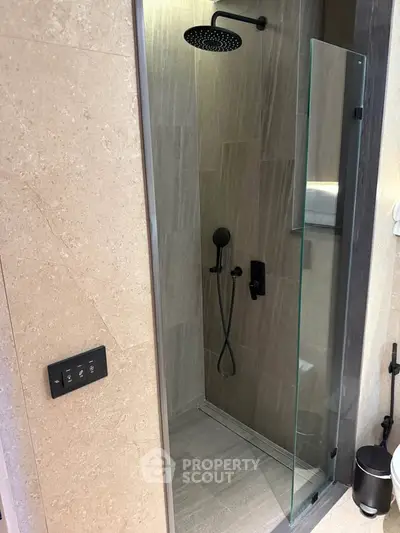 Modern bathroom with sleek shower design and elegant fixtures, perfect for a luxurious home experience.
