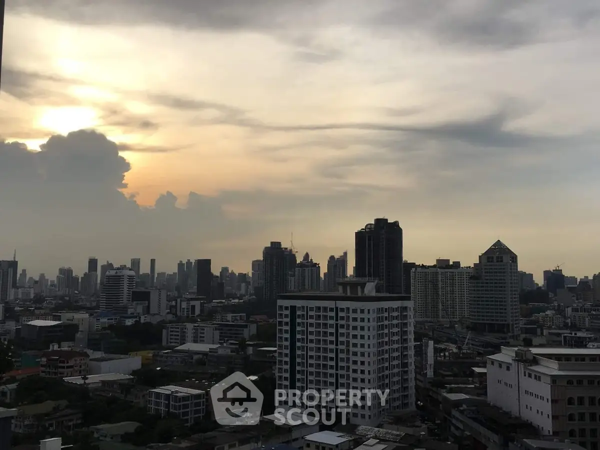 Stunning city skyline view at sunset with high-rise buildings and dramatic clouds.