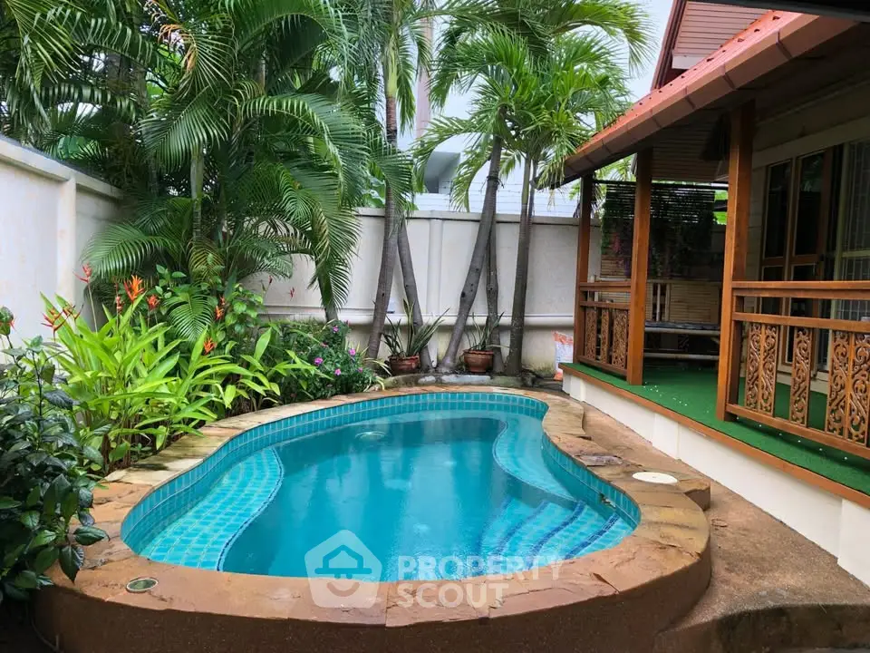 Charming tropical garden with a cozy pool and lush greenery, perfect for relaxation.