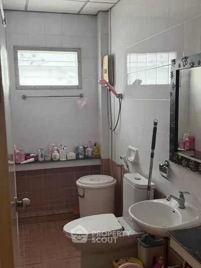 Cozy bathroom with essential amenities and natural light