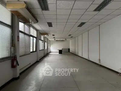 Spacious office space with large windows and ample natural light, ideal for business setup.