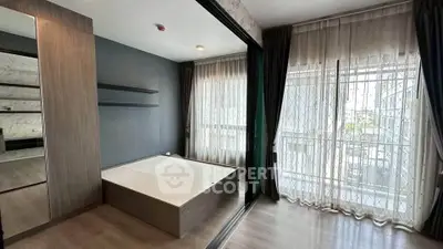 Modern bedroom with large windows and sleek wooden furnishings