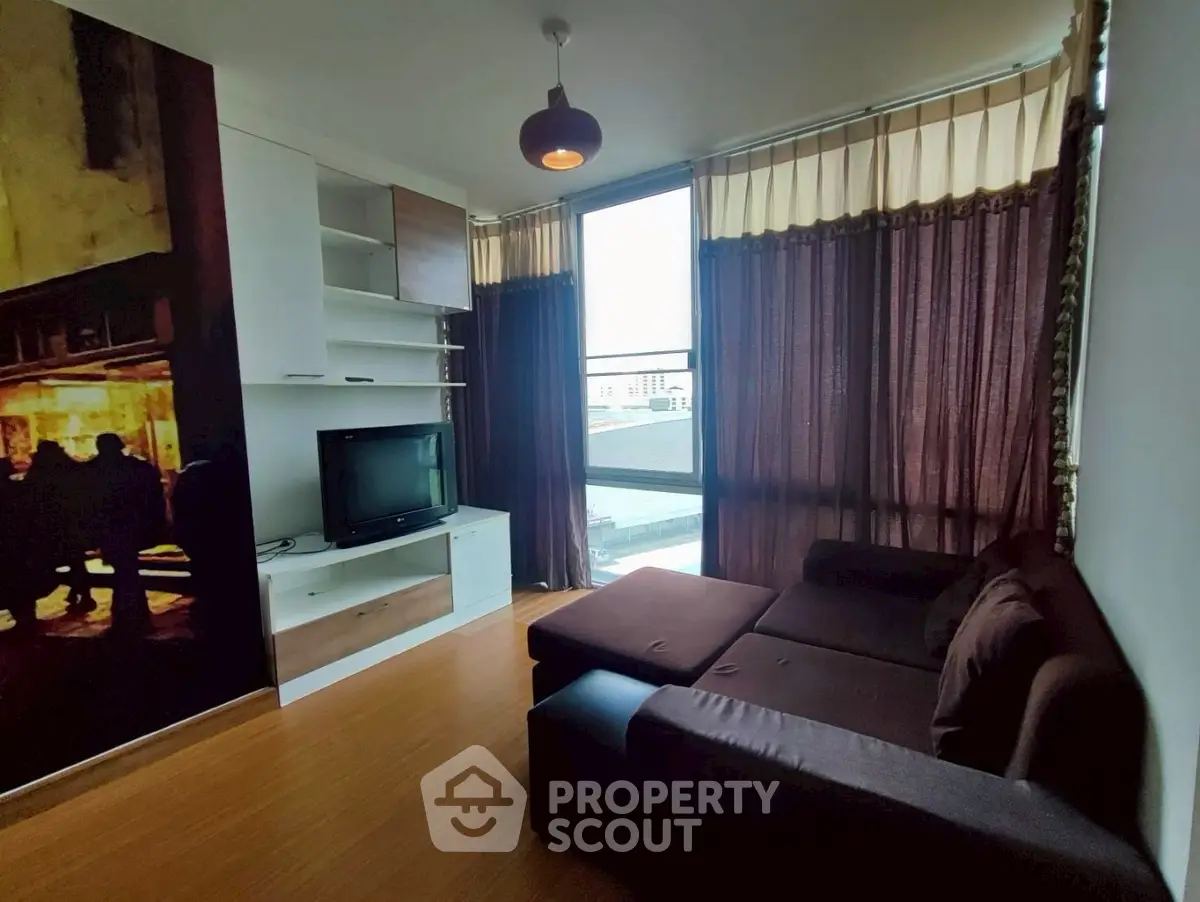 Cozy living room with modern decor and large windows for natural light.
