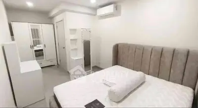 Modern bedroom with stylish furniture and air conditioning in a cozy apartment.