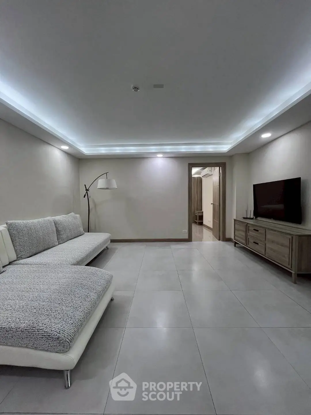 Spacious modern living room with sleek lighting and minimalist decor