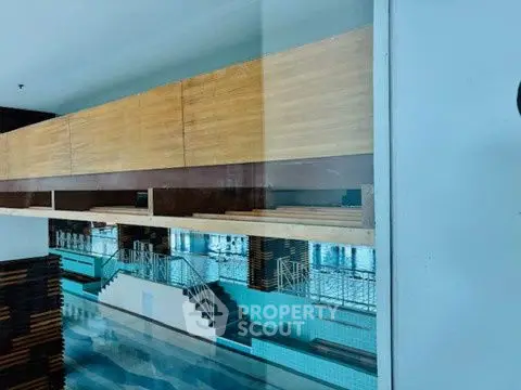 Spacious indoor pool area with modern design and wooden accents