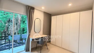 Modern bedroom with large wardrobe and balcony view