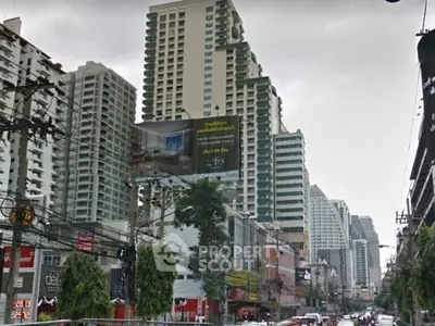 Urban cityscape with high-rise buildings and bustling street view.