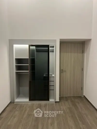 Modern walk-in closet with sleek sliding doors and ample storage space