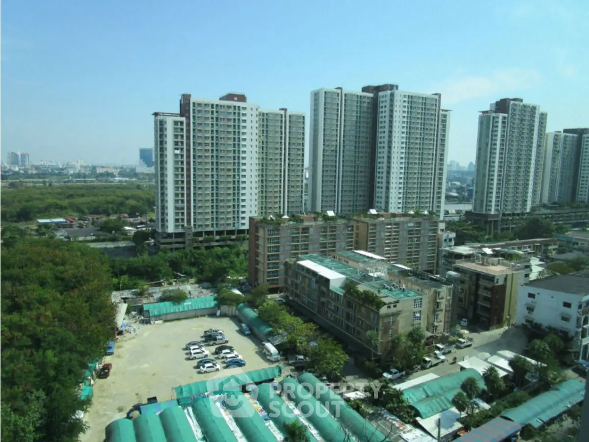 Panoramic view of modern high-rise residential buildings with lush greenery and urban landscape.