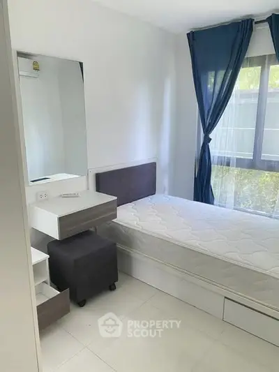 Cozy bedroom with natural light and modern furnishings