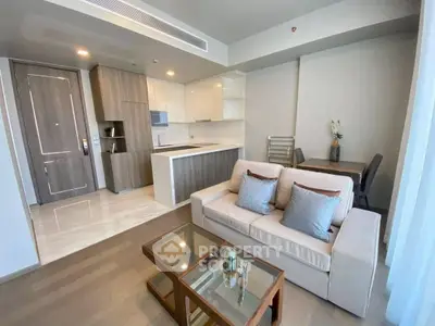 Modern living room with open kitchen and stylish furniture in a cozy apartment.