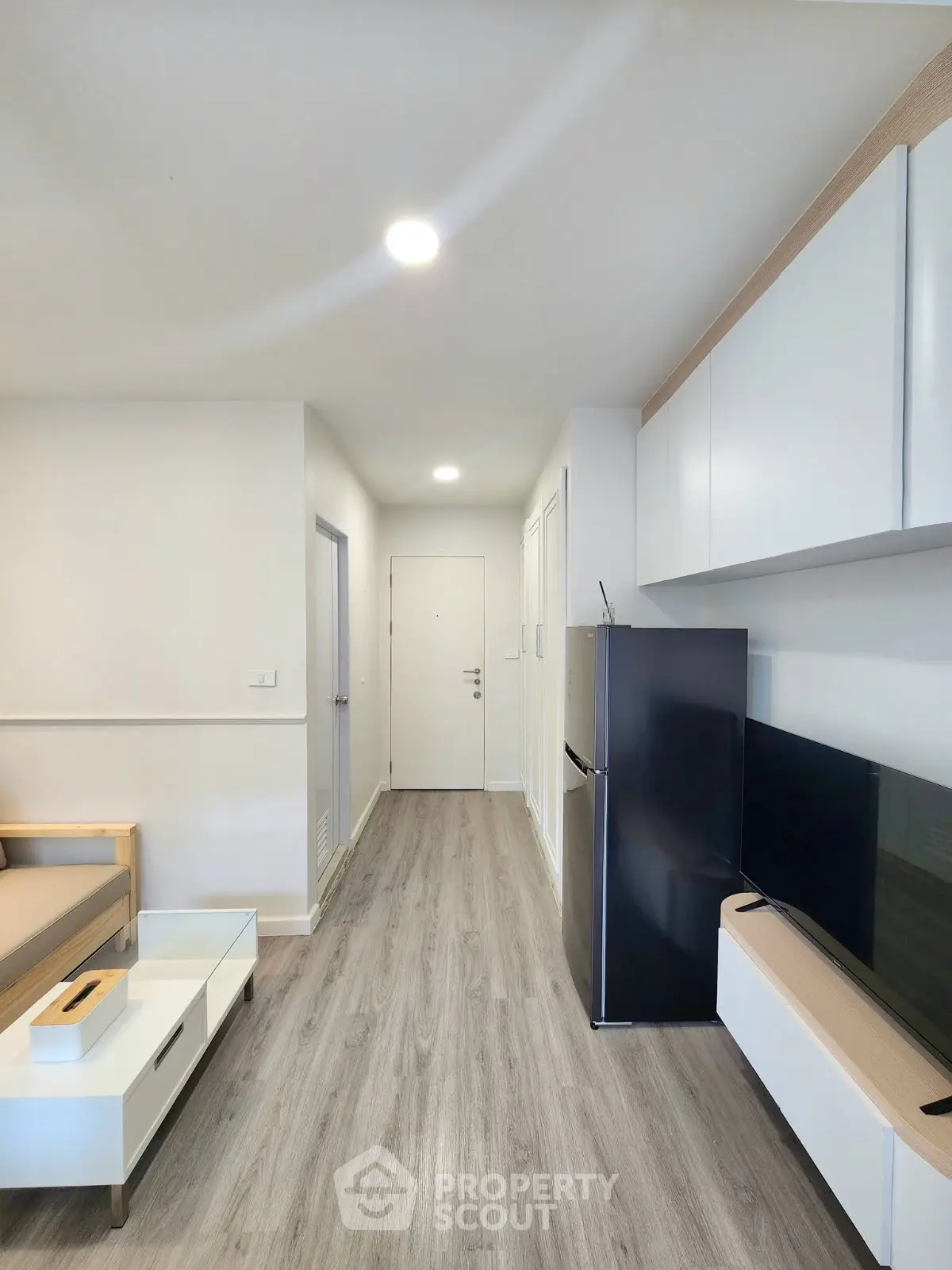 Modern living room with sleek furniture and stylish flooring in a contemporary apartment.