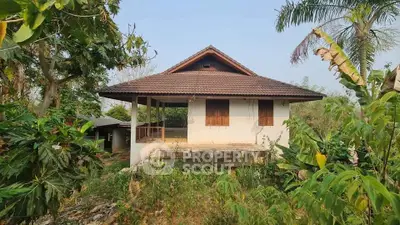 Charming rustic house surrounded by lush greenery, perfect for nature lovers seeking tranquility.