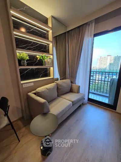 Modern living room with cozy sofa and balcony view in urban apartment