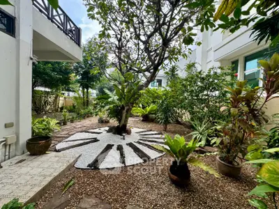 Charming garden oasis with lush greenery and unique landscaping in residential property
