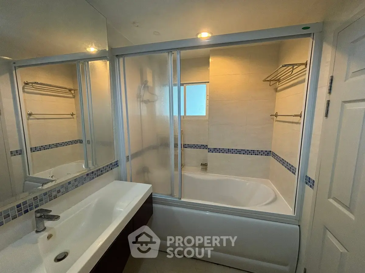 Modern bathroom with bathtub and sleek fixtures in a stylish real estate property.