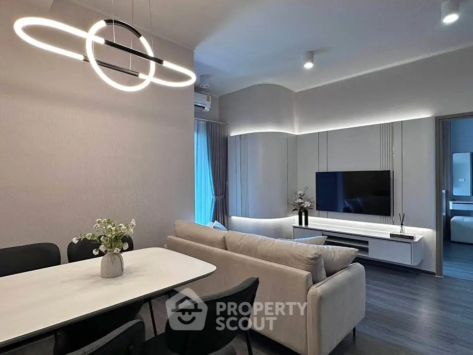 Modern living room with sleek furniture and stylish lighting in a contemporary apartment.