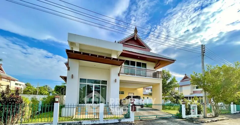 Stunning two-story house with traditional roof design and spacious driveway