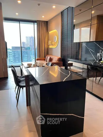 Luxurious modern kitchen with sleek black island and open layout, featuring city view through large windows.